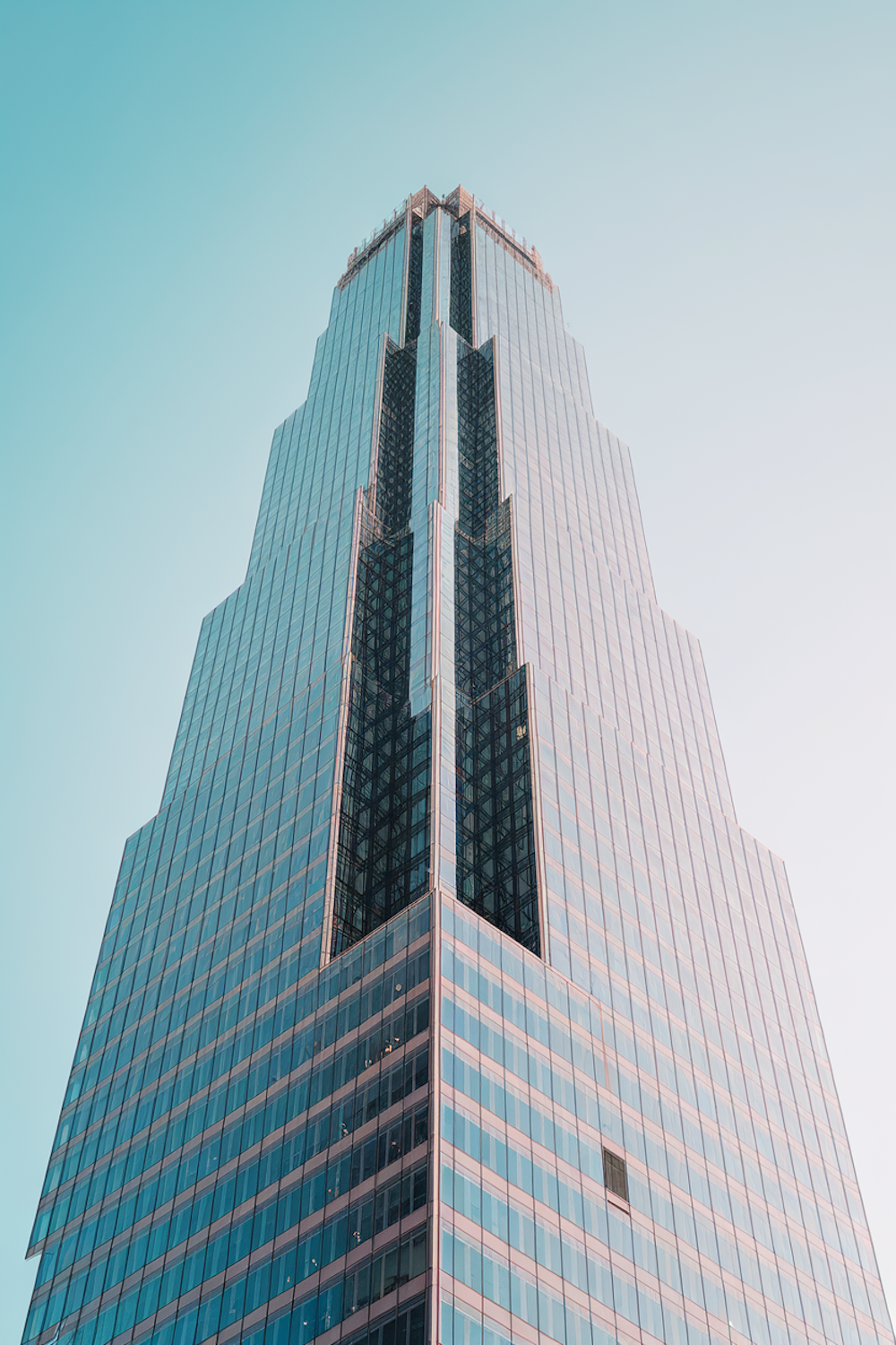 A downtown commercial office tower rising against a clear sky